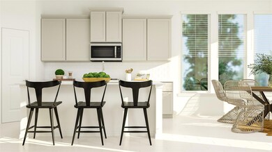 Kitchen with tasteful backsplash and gray cabinetr