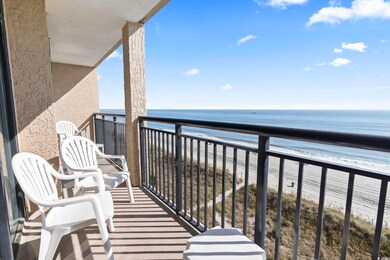 Balcony with a water view and a view of the beach