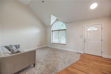 Entryway featuring lofted ceiling and light hardwood / wood-style floors