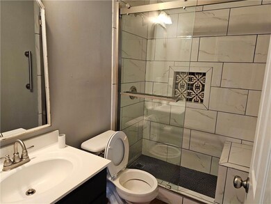 Full bath with a stall shower and vanity