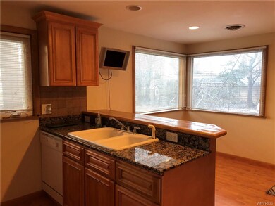 Perfect kitchen with granite counters, wall of win