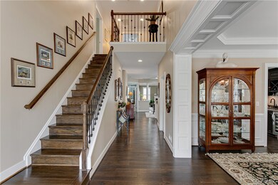 Hardwood floored foyer featuring ornamental moldin