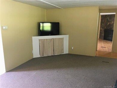 Living Room Has Custom Shelving for Entertainment 
