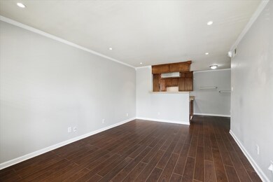 Bright and light.  Recessed lighting and crown molding.