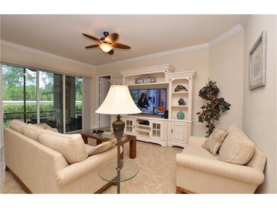 Great room with crown molding, tile on the diagonal and sliders to the lanai.