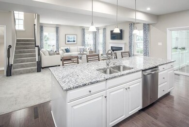 Complete open concept on the main level with the kitchen opening to the dining area and great room!  *Photos of a current Model*