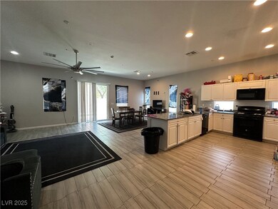 Kitchen featuring black appliances, recessed light