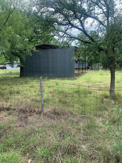 View of yard with fence, a pole building, and an 