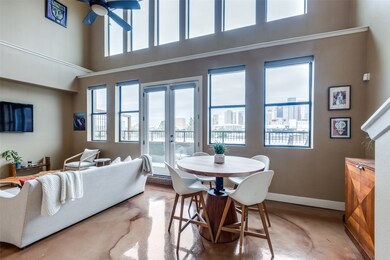 Open living/dining with high ceilings and windows,