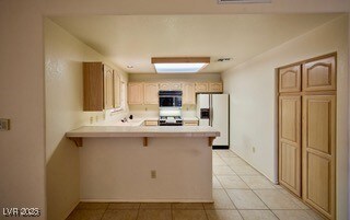 Kitchen featuring light countertops, a breakfast b