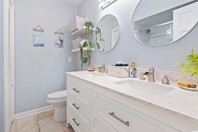 Bathroom with vanity, toilet, and walk in shower