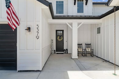 Doorway to property featuring board and batten siding and a garage