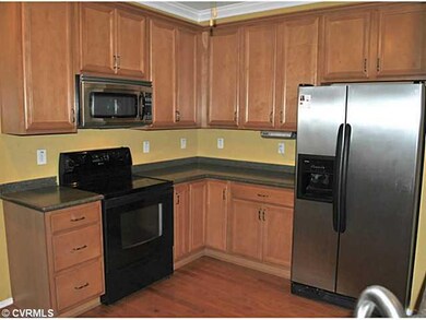 Kitchen - The kitchen has hardwood floors, maple c