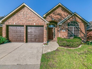 Front of property with a garage and a front lawn