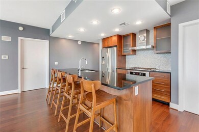 Kitchen featuring wall chimney exhaust hood, appl