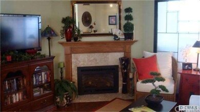 Living Room with fireplace, hardwood flooring, gla