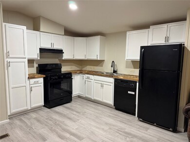 Kitchen with lofted ceiling, under cabinet range h