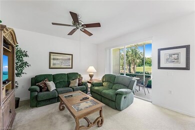 Carpeted living room with ceiling fan