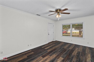 Empty room featuring a textured ceiling, dark hard