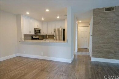 View From Entry Into Dining Area, Kitchen, and Hal