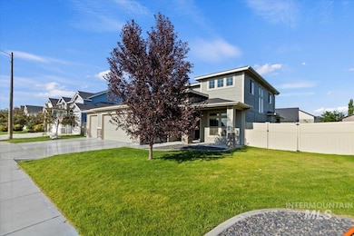 View of front of property featuring an attached garage and concrete driveway