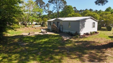 Exterior space featuring metal roof and a front ya