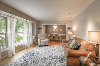Inviting bright front living room open to the dini