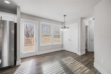 Unfurnished dining area featuring dark hardwood / 