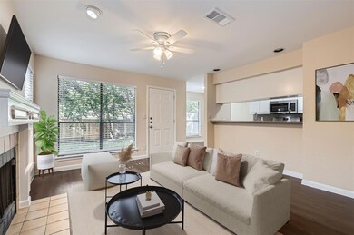 Living area with a tiled fireplace, wood finished