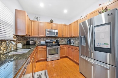 Kitchen featuring light wood finished floors, a si