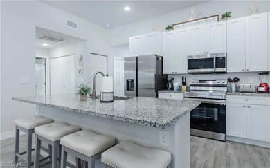 Kitchen featuring a kitchen breakfast bar, applian