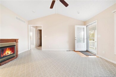 Living room offers vaulted ceiling with a gas fire