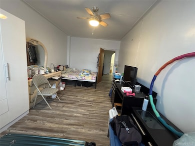 Bedroom with dark wood finished floors and ceiling fan