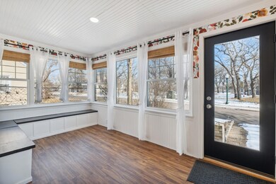 Sunny front porch with new flooring and newer windows!