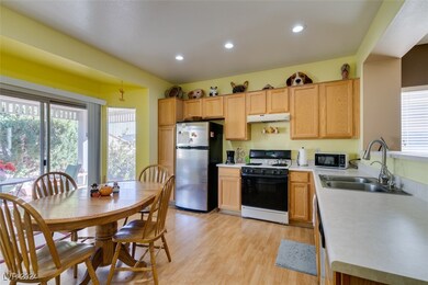 Eat-in kitchen with breakfast bar and sliders to b