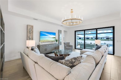 Living room with a notable chandelier and a tray c