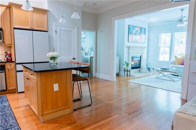 Kitchen with fridge, a center island, light hardwo