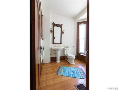 Guest lavatory with period lighting and mirror