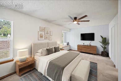 Bedroom with carpet, a textured ceiling, and ceiling fan. This is a virtually staged photo.