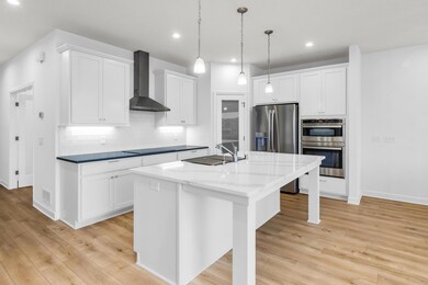 Lifestyle gourmet kitchen loaded with upgrades. Ample storage with dedicated pantry, upgraded cabinetry, quartz countertops, GE Profile Appliances with induction cooktop, (option to switch to gas cooktop) exhaust hood, and double wall oven.