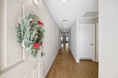 Entry with vinyl flooring welcomes you home and leads to a bright living area, kitchen, and dining area.