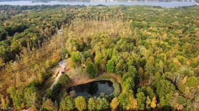 Aerial view of property and surrounding area featuring a nearby body of water