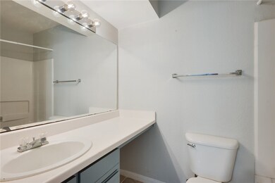 Bathroom with walk in shower, vanity, and toilet