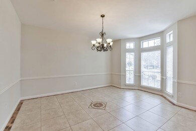 The dining room is large and has great detail with its bay window and chair rail