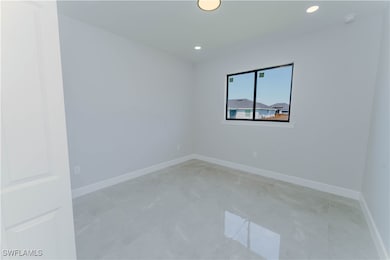 Empty room with baseboards and recessed lighting