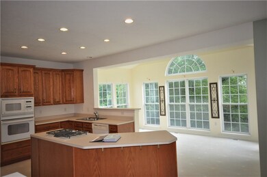Large island and wall of windows enhance this spac
