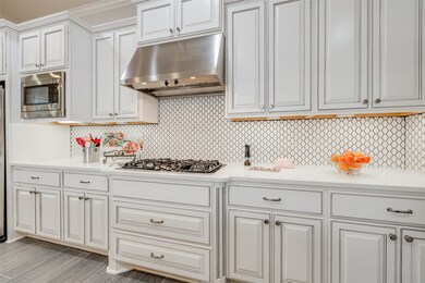 Gorgeous cabinetry and designer backsplash