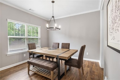 Dining space with dark wood finished floors, ornam