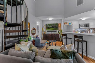 Living area featuring a towering ceiling, wood fi