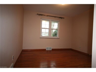 Two bedrooms with hardwood floors on the first flo
